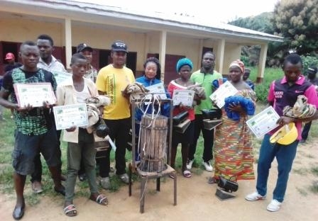 Participants with 1 of 3 honey press bee suits and smokers